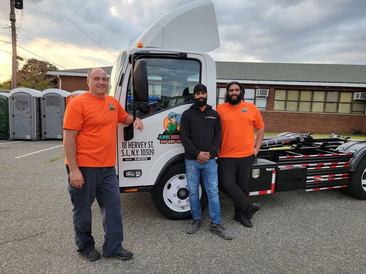 Junk Heroes owner and crew standing beside a Junk Heroes truck