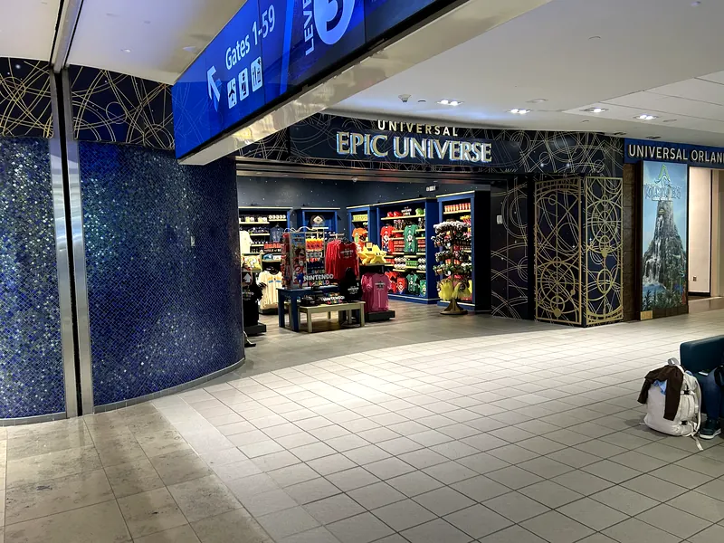 Universal Epic Universe retail store at Orlando International Airport near the Gates 1-59 Level 3 sign