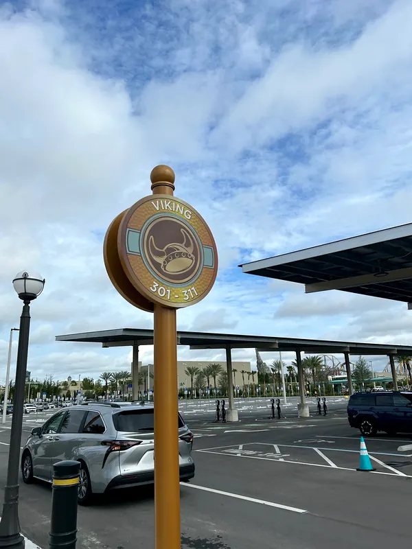 Viking 301-311 parking lot sign at Epic Universe with solar canopies behind it