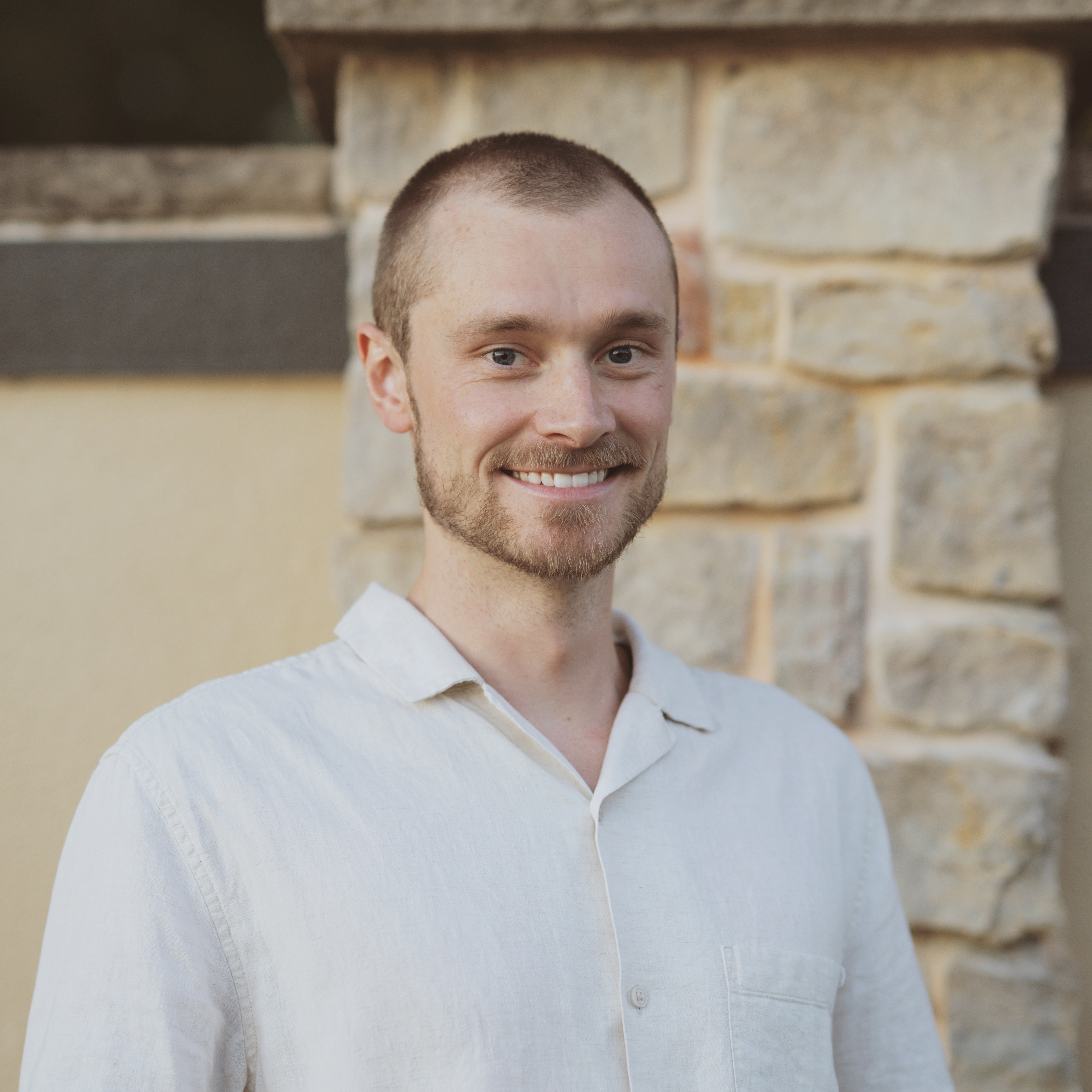 woman sitting on modern couch using laptop in futuristic workspace with purple lighting, symbolizing innovative digital strategy and creative development