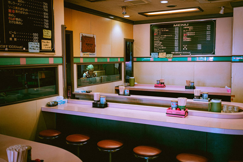 An empty restaurant and a chef
