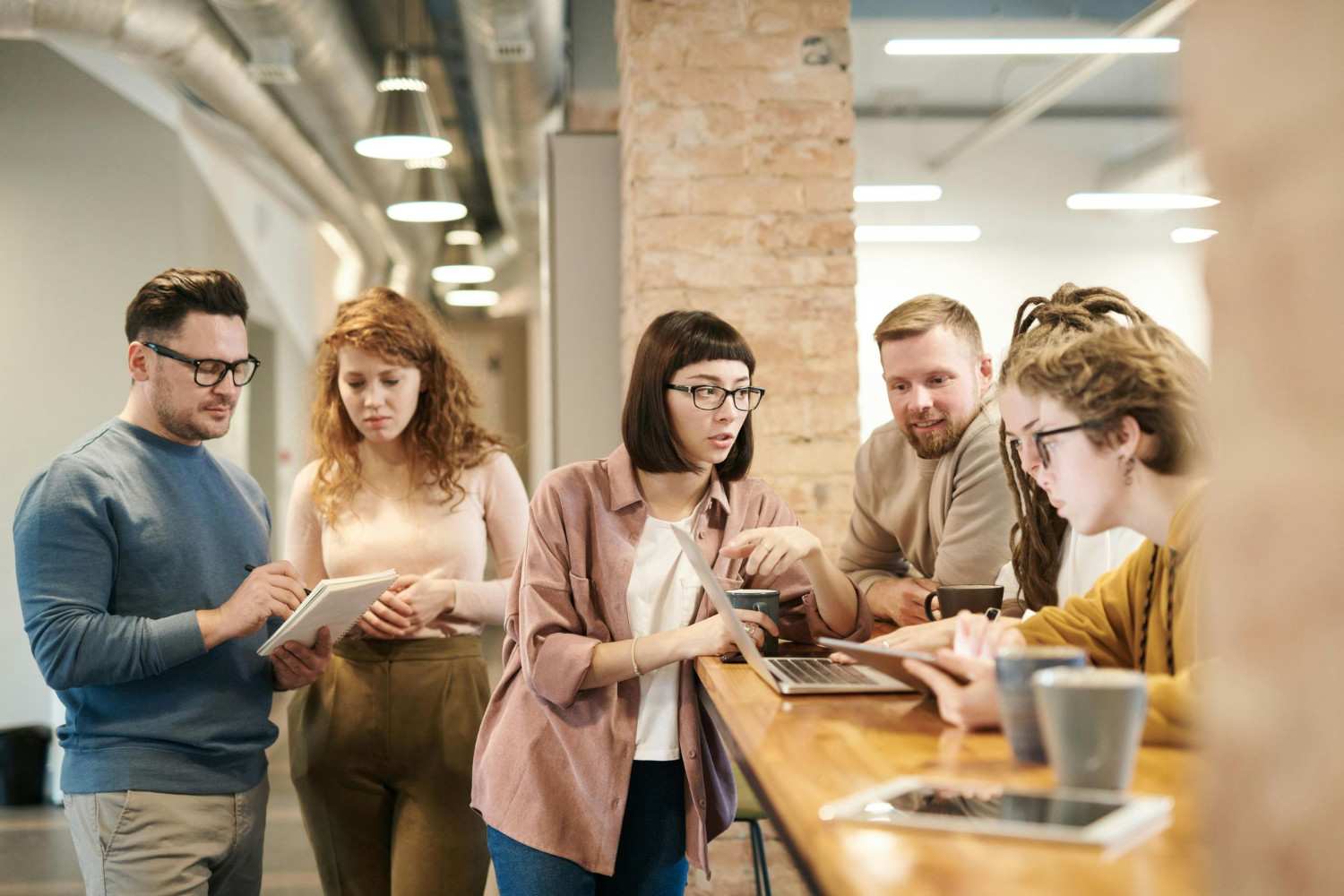 People collaborating in a shared workspace environment facilitated by Wayo