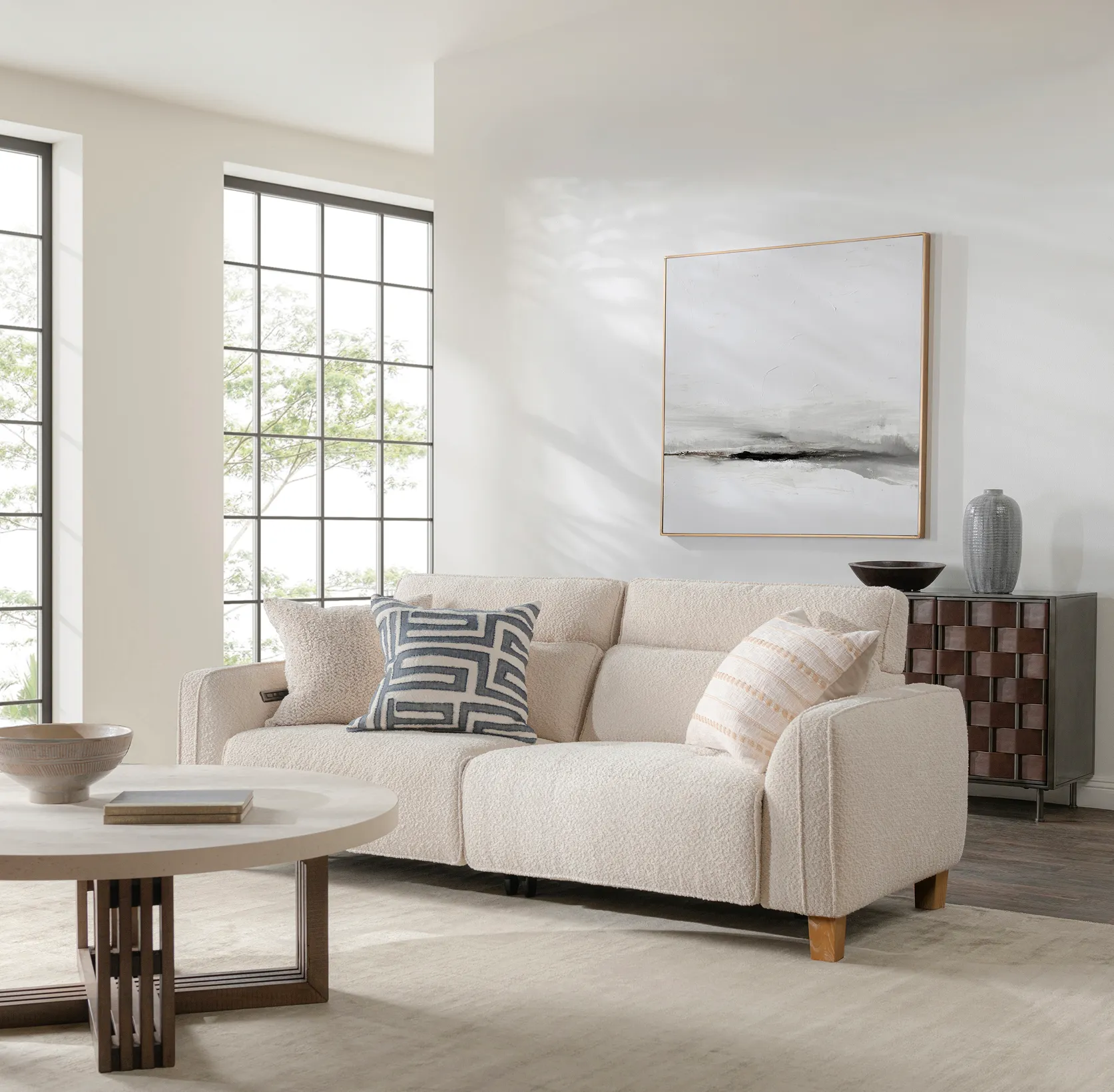 White sofa with brown wooden coffee table and two light brown pillows 