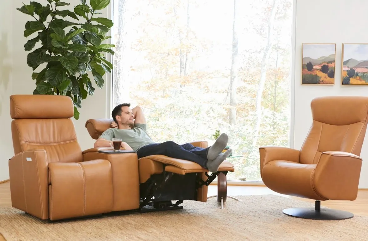 Leather entertainment sofa with man reclining back and leather accent chair