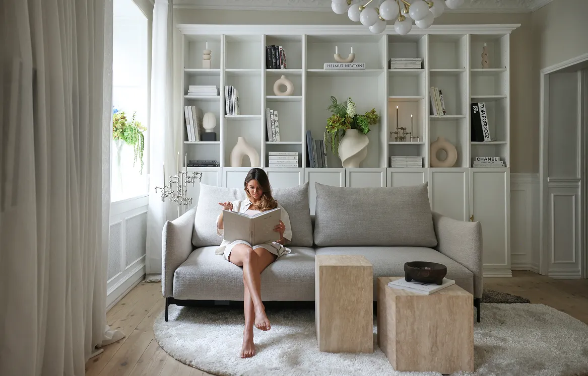 White sofa from Innovation Living with woman reading book 