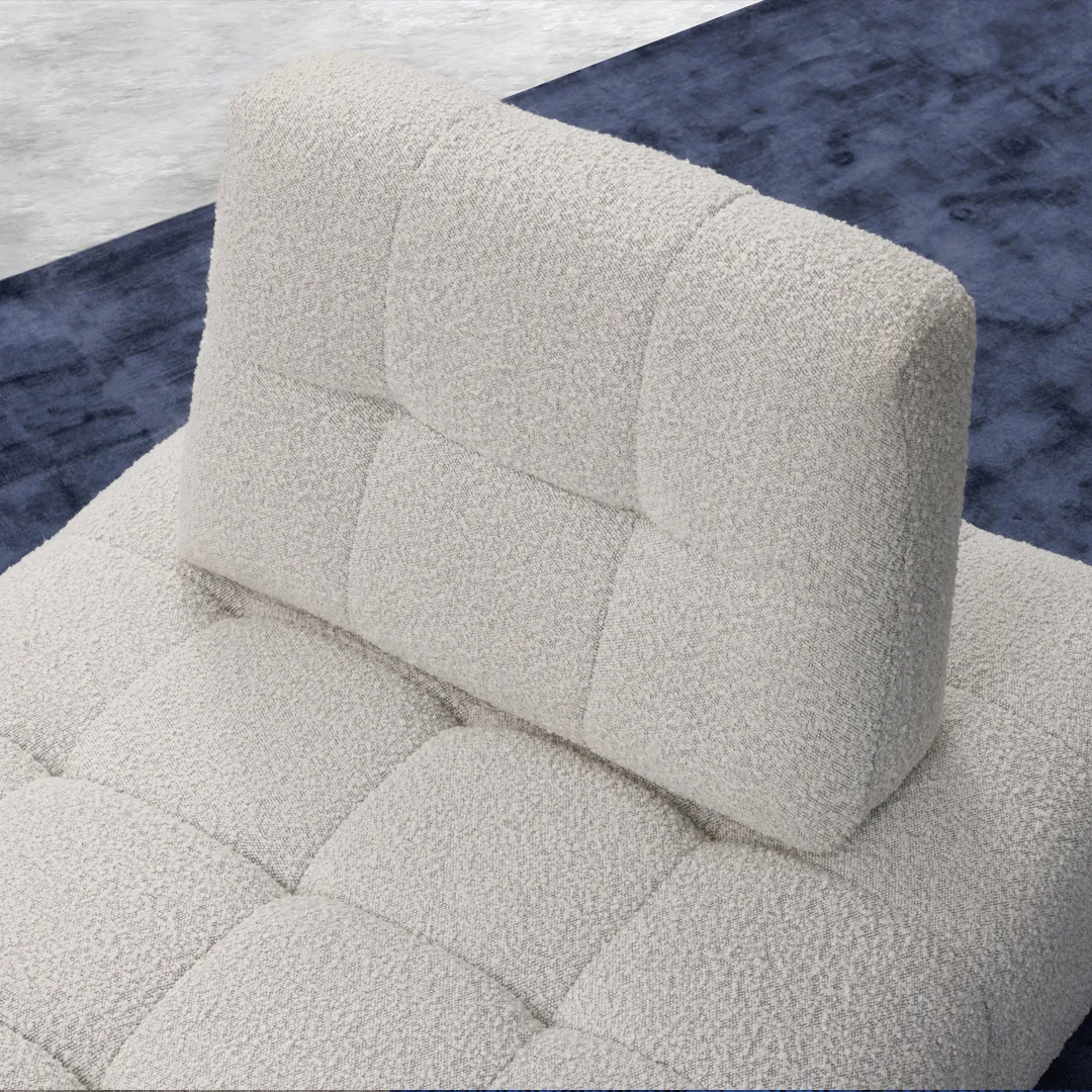 Close up of white fabric seat with blue rug underneath 
