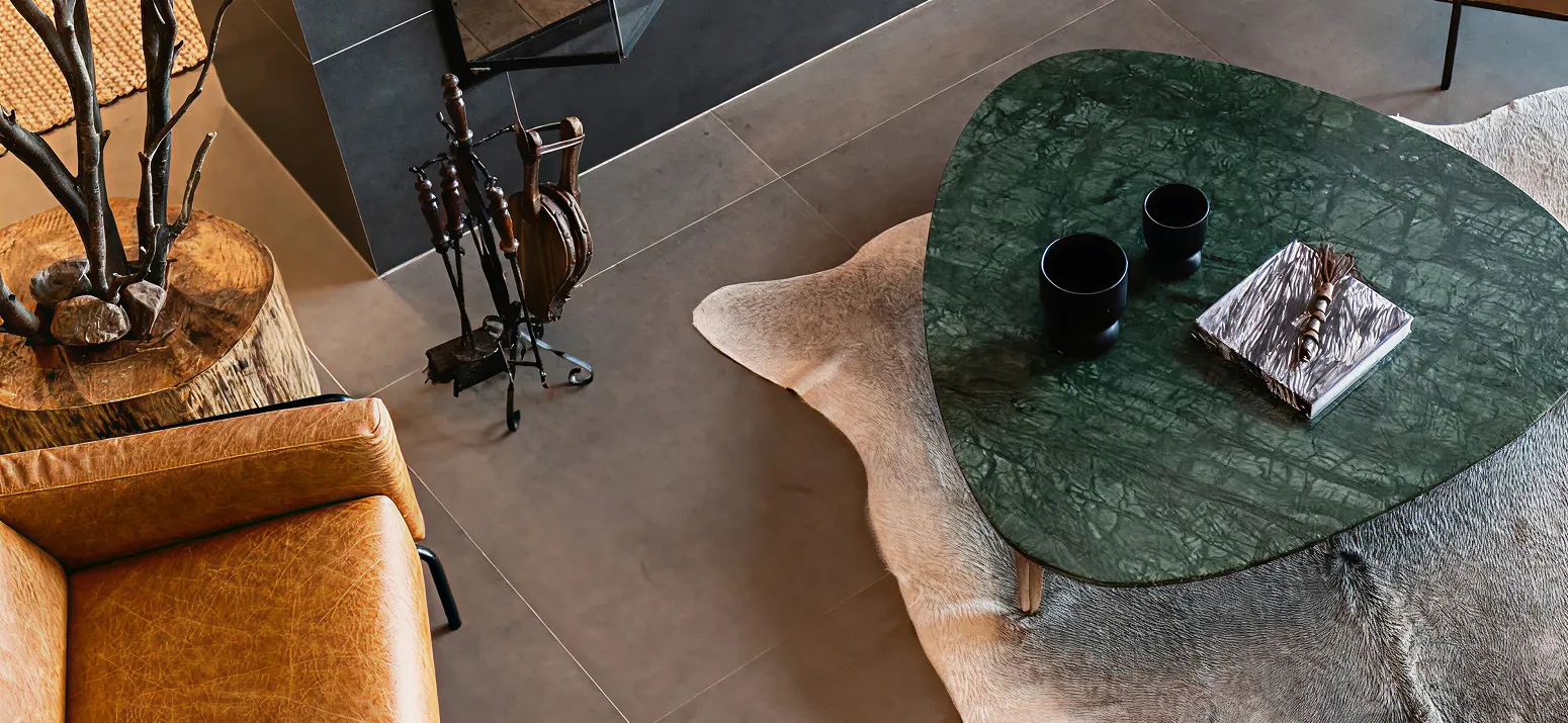 Uultis triangle green coffee table with white animal rug underneath 