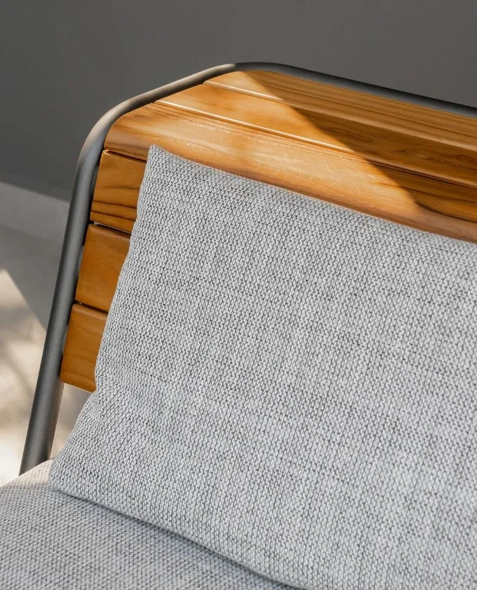 Uultis up-close shot of wooden chair with grey cushions 