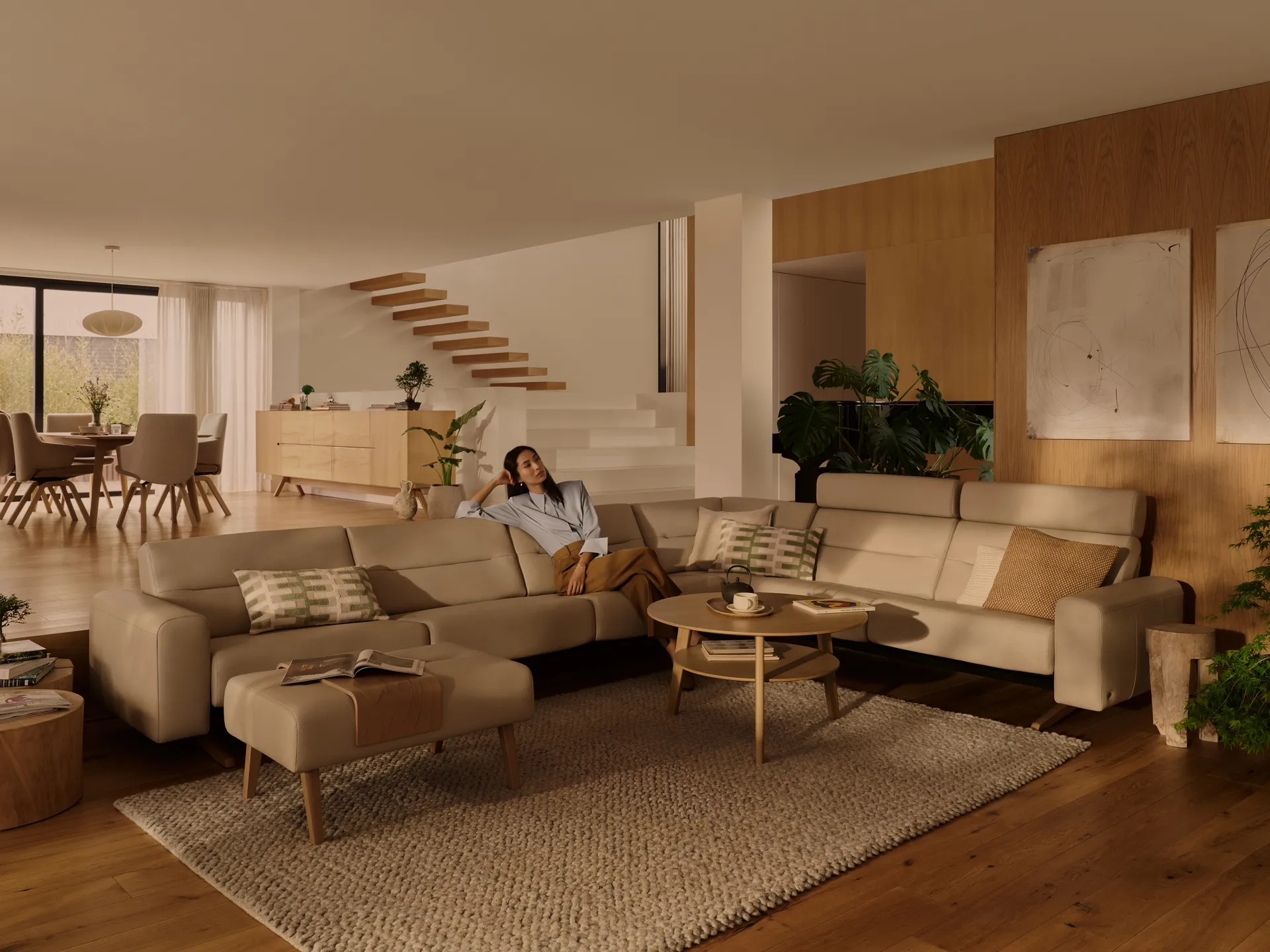 A woman sits in the middle of a white sectional 