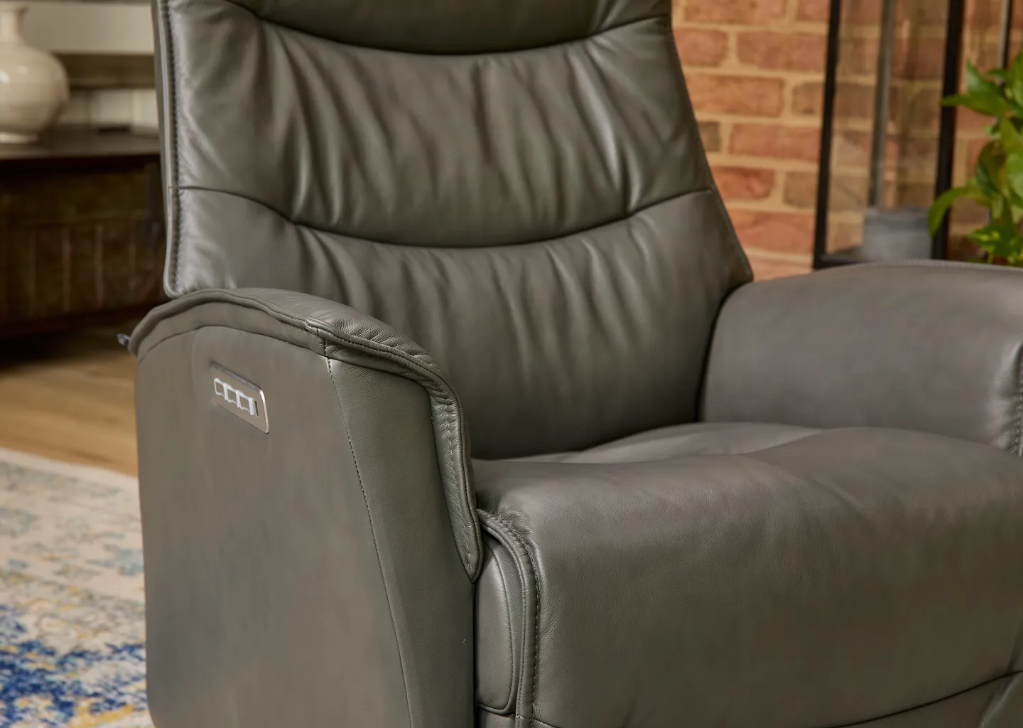 A dark grey recliner 