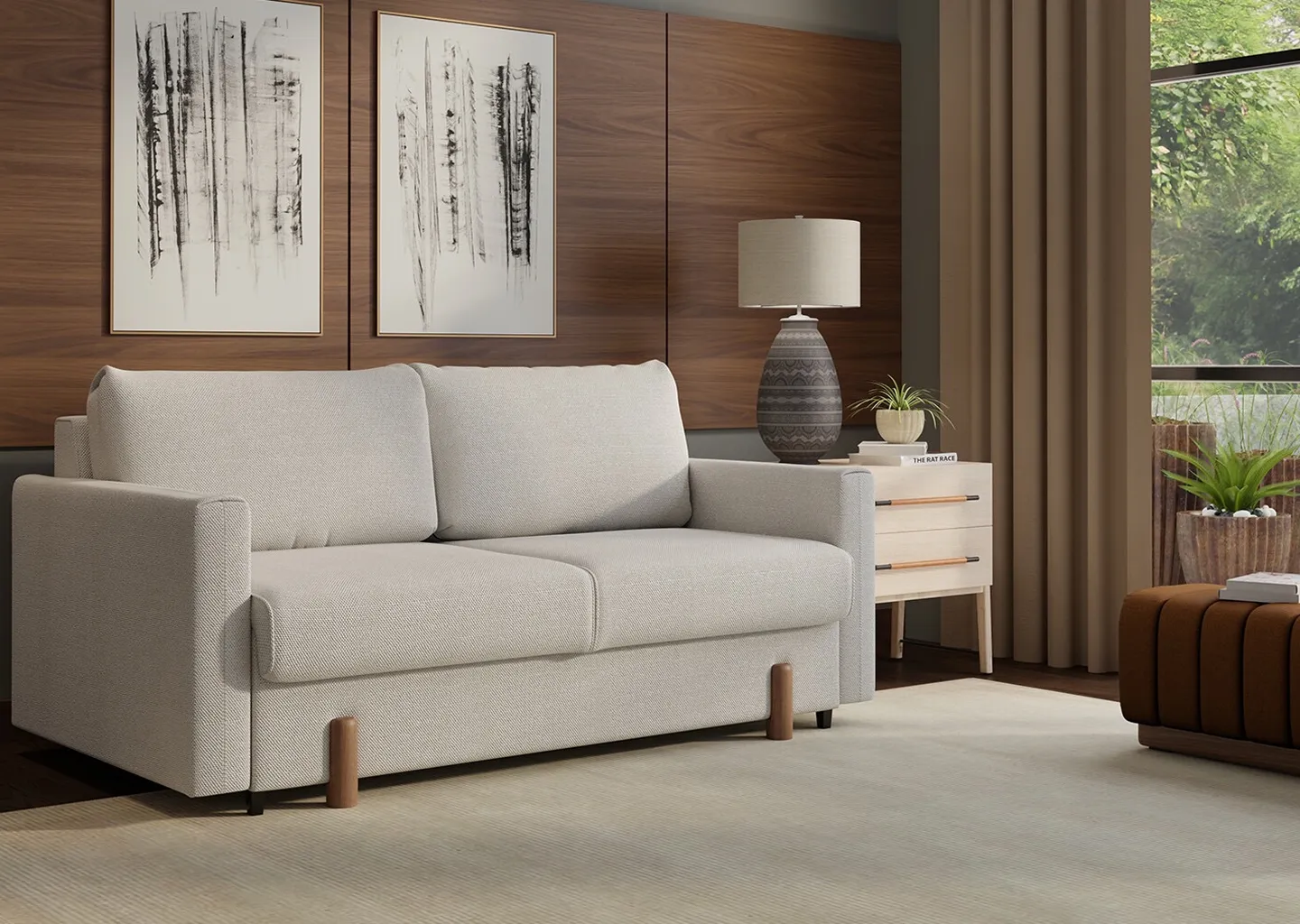 White sleeper sofa with white rug underneath and wooden wall as backdrop 