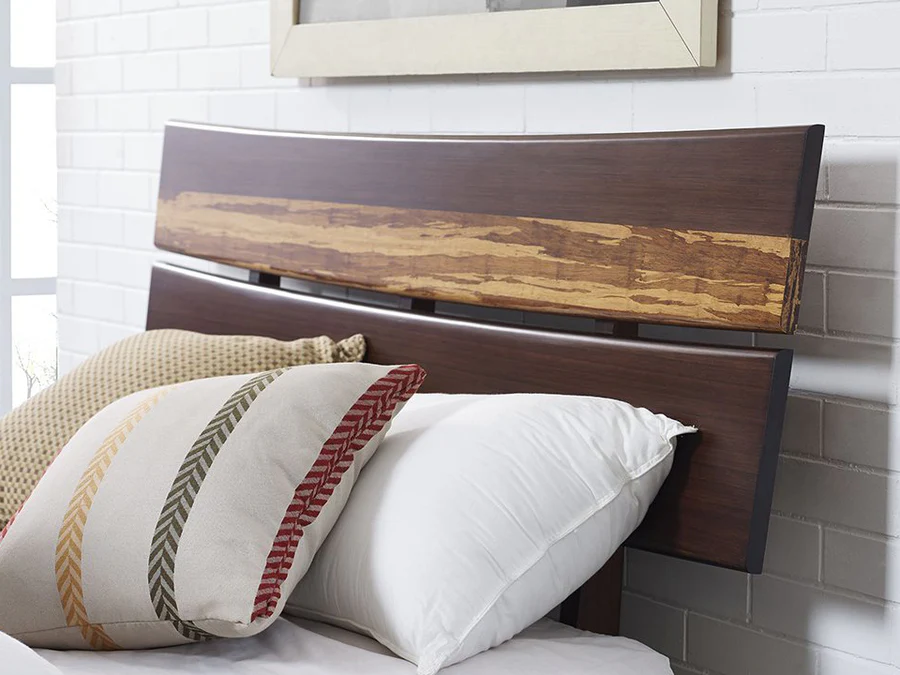 A bamboo bedroom headboard in a dark oak color with a light oak streak across the headboard