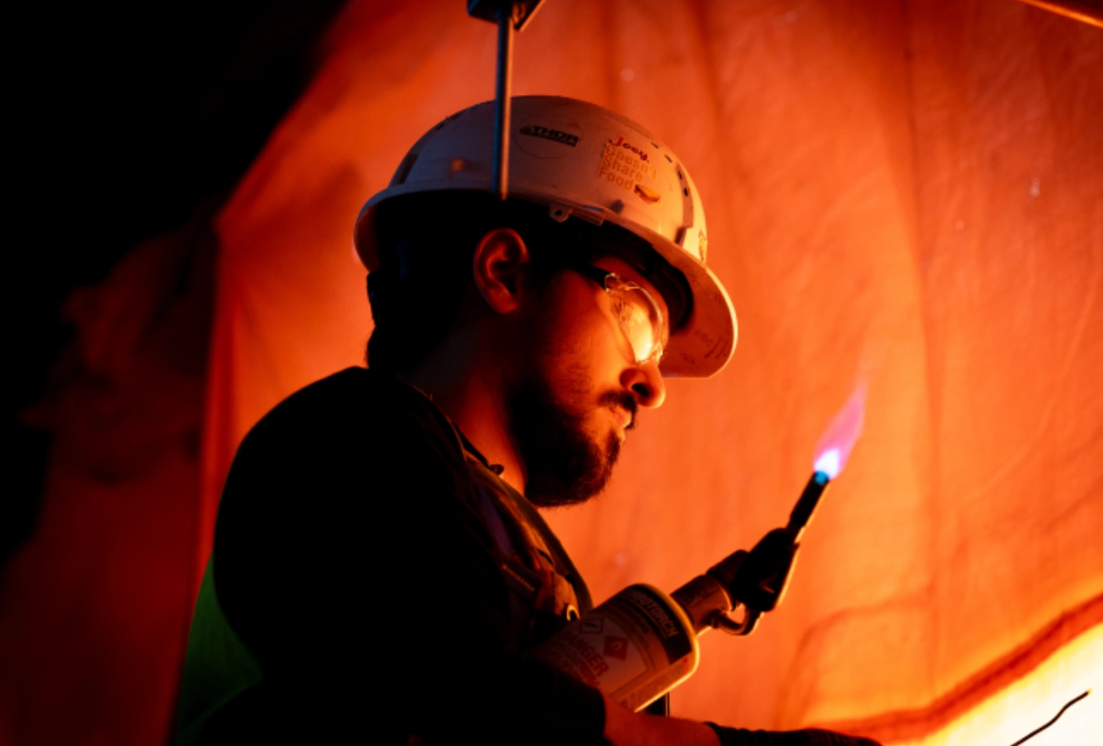 Plumber using torch for soldering work on construction project in Saskatoon Saskatchewan