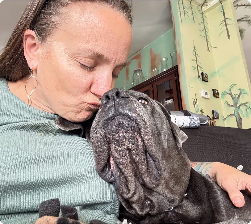 Woman relaxing on couch with her support animal after a healing session