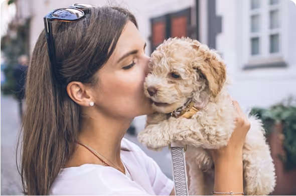 Smiling woman walking with her trained ESA dog in a calming outdoor setting