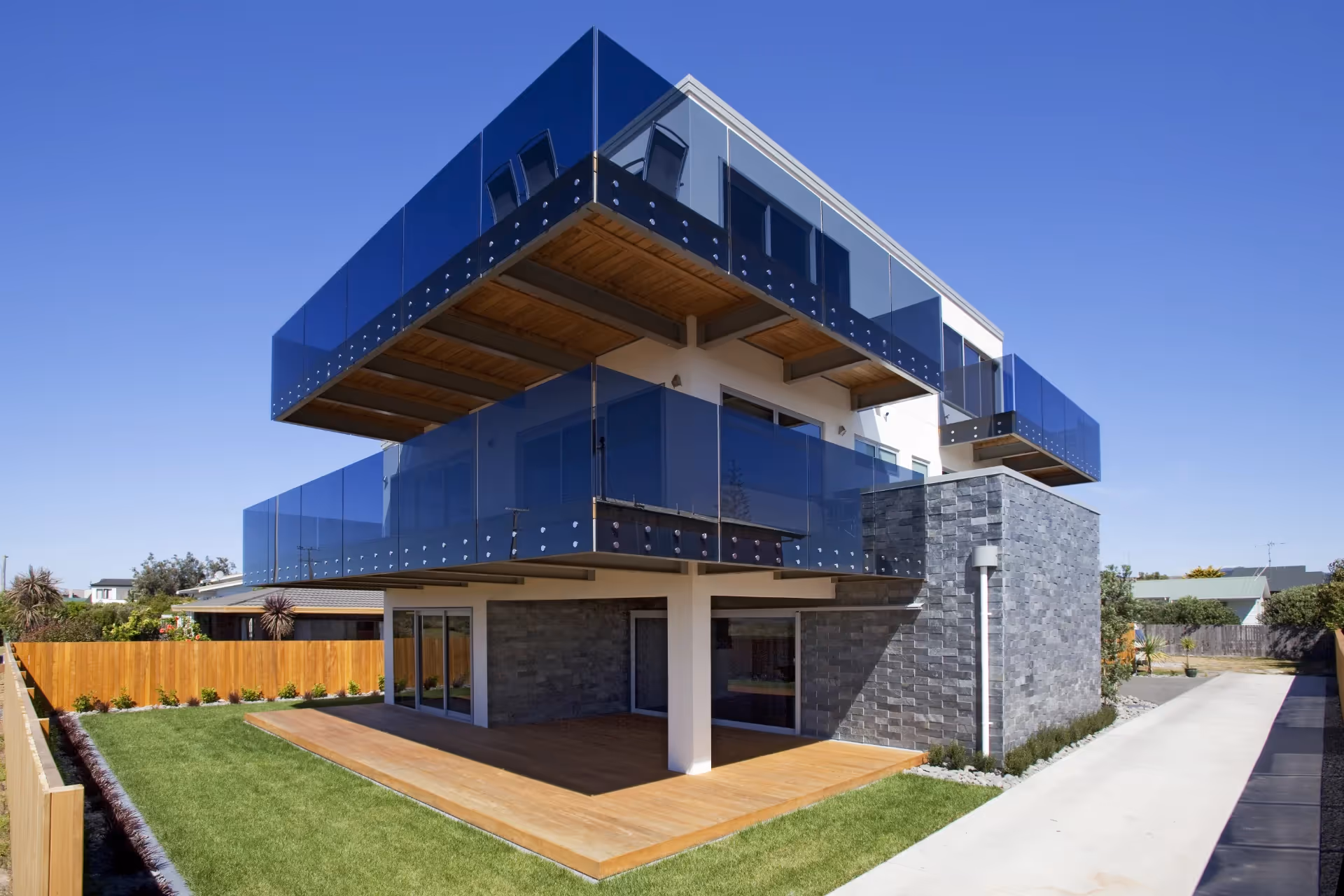 Glass balustrade on outside of two-story building. 