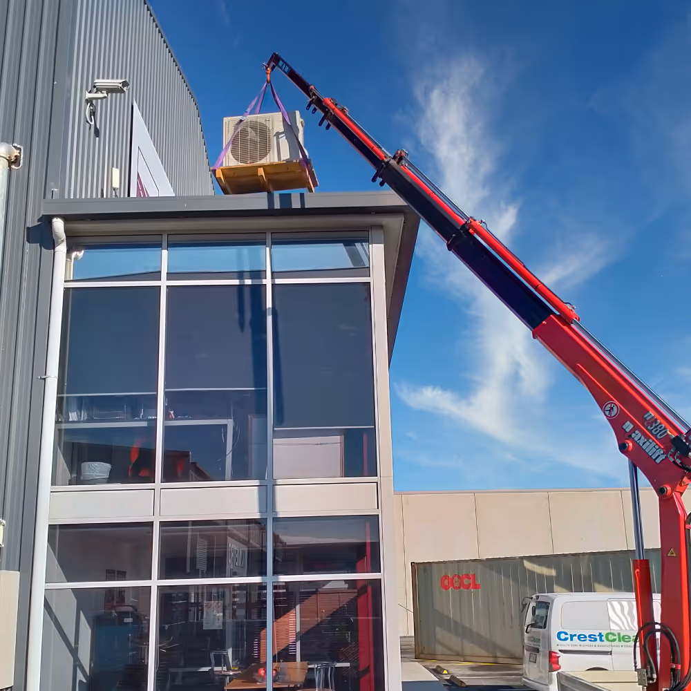 Hi, Ab, lifting air conditioning unit onto office building. 