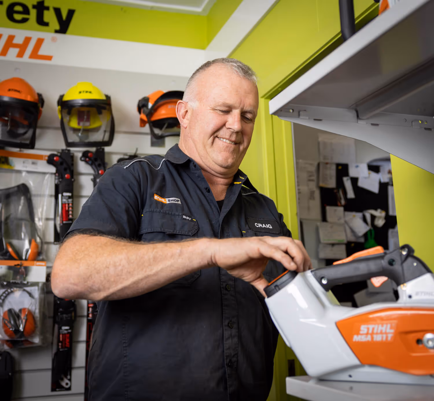 Man fixing hedge trimmer. 