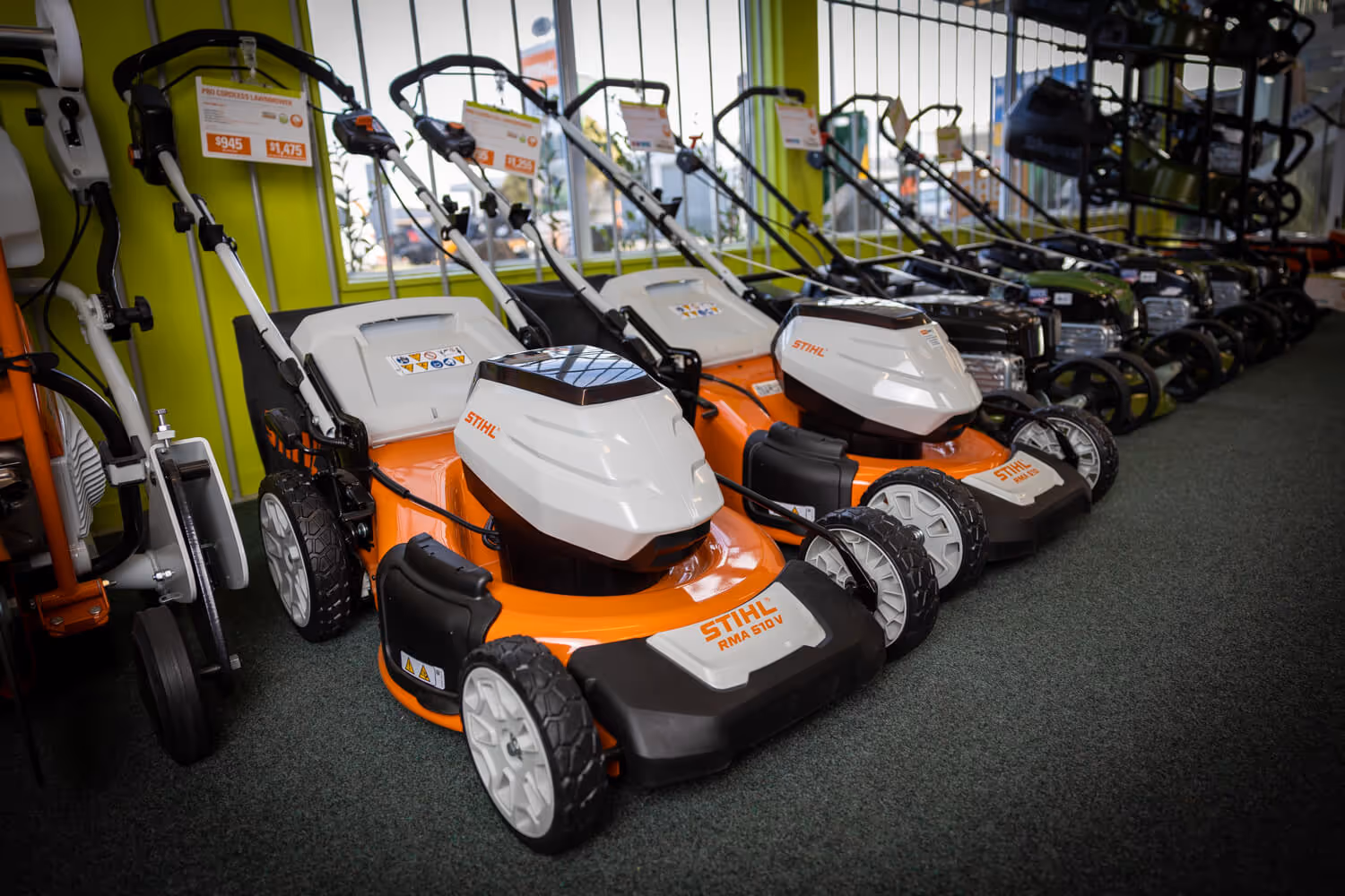 A line up of still lawn mowers. 