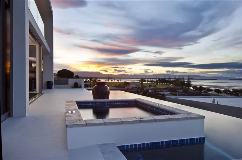 Exterior of home looking over pole in evening. 