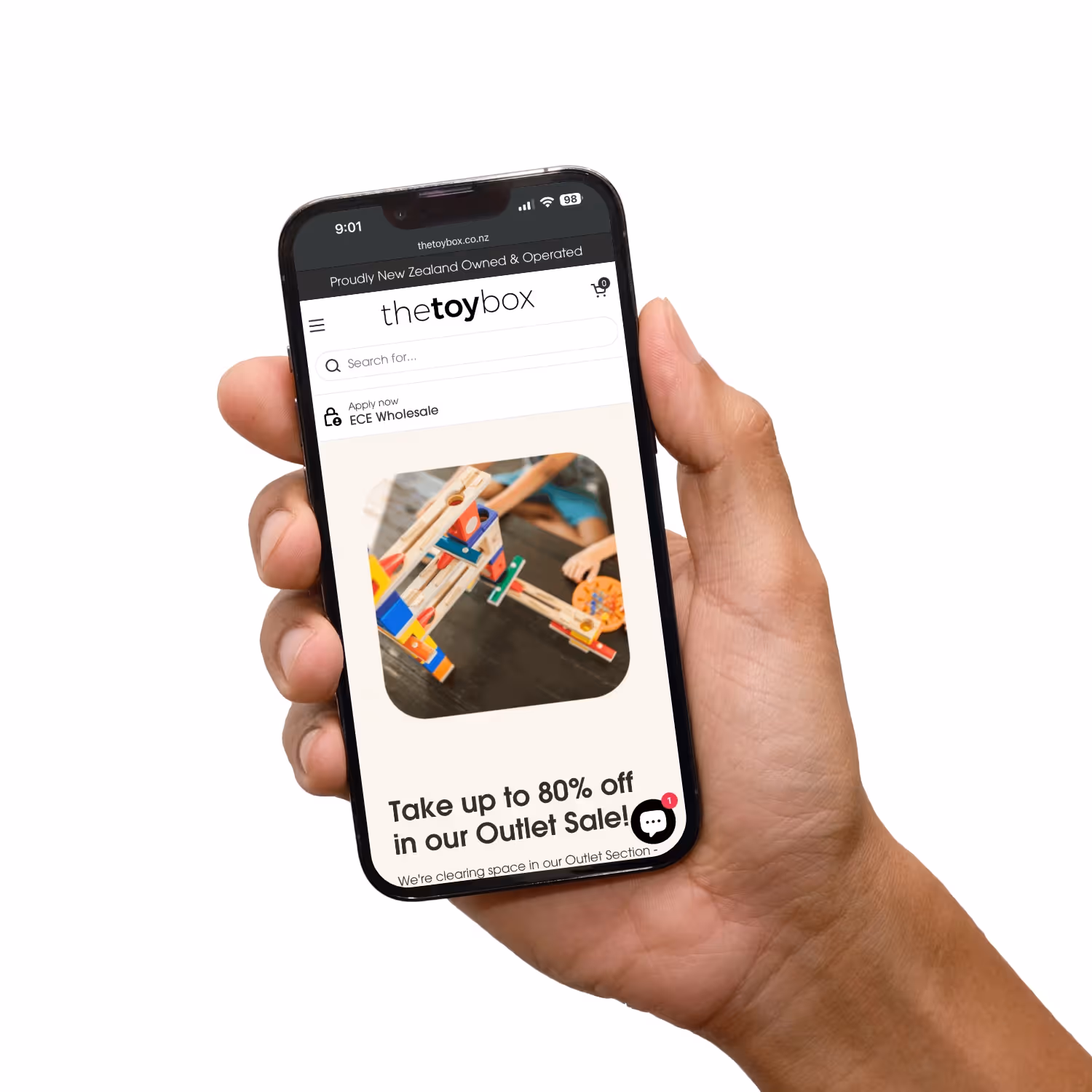 Hand holding mobile phone with Toybox website.