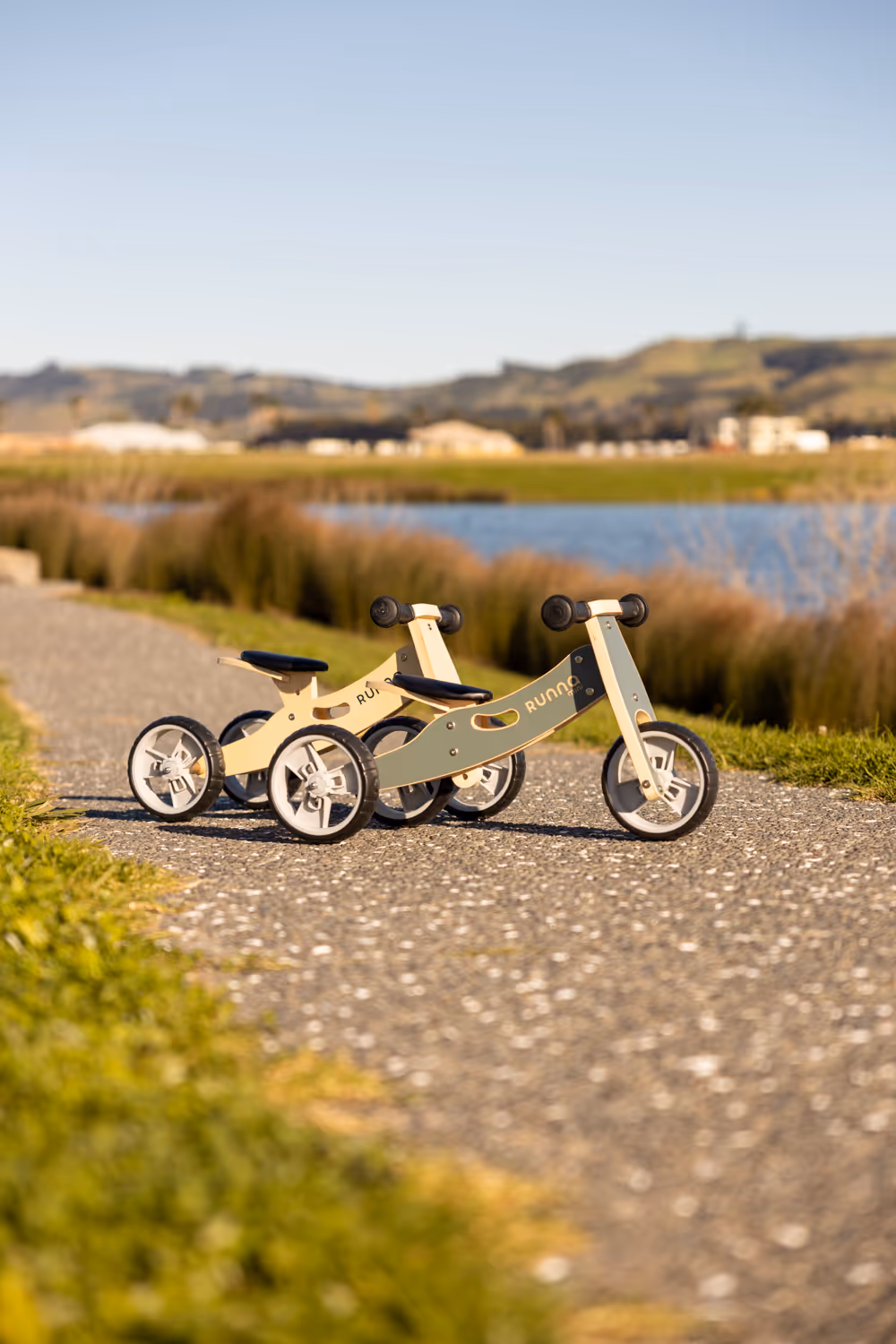 Two wooden tricycles on path. 