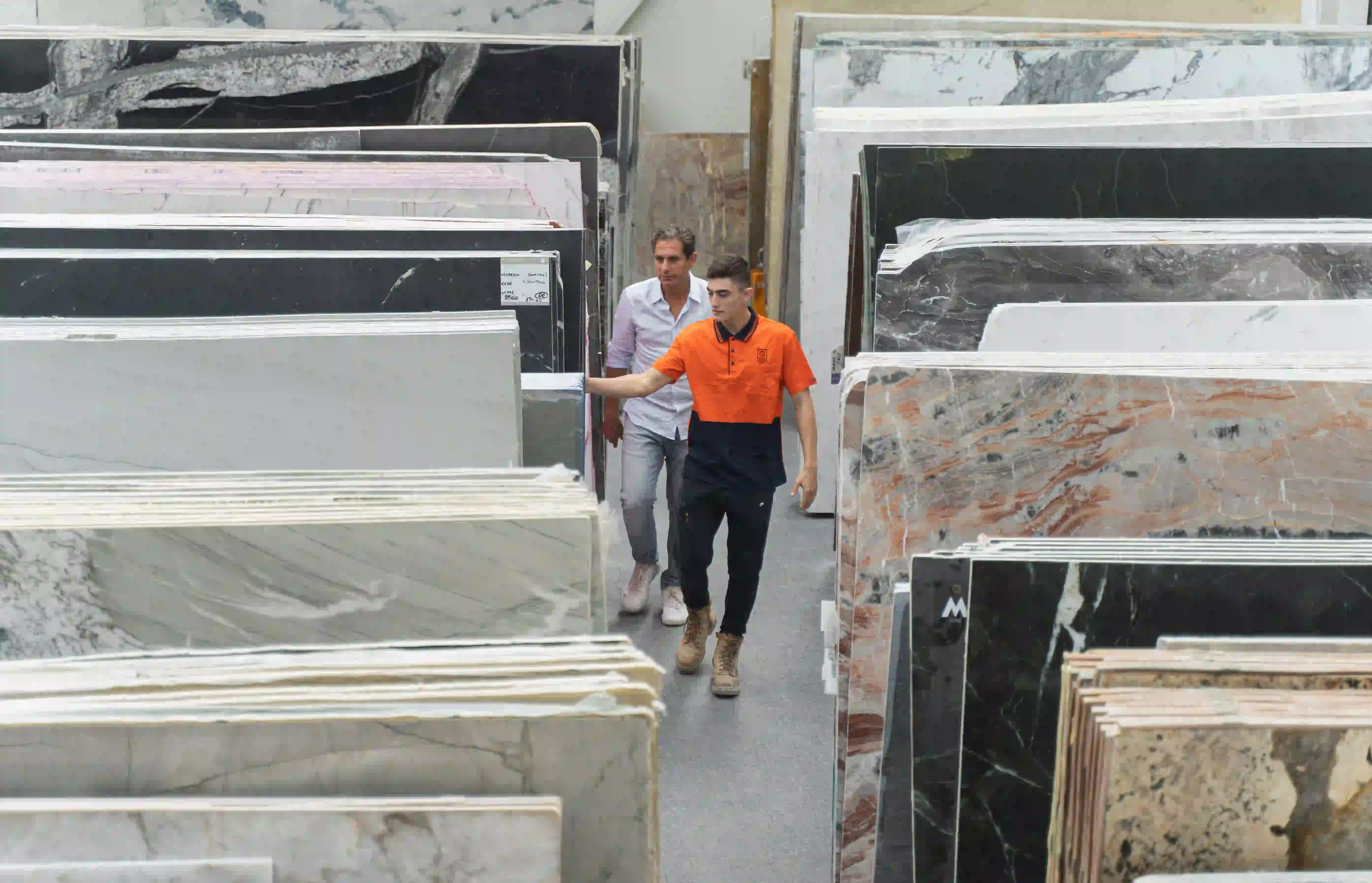 Employees walking through a natural stone gallery