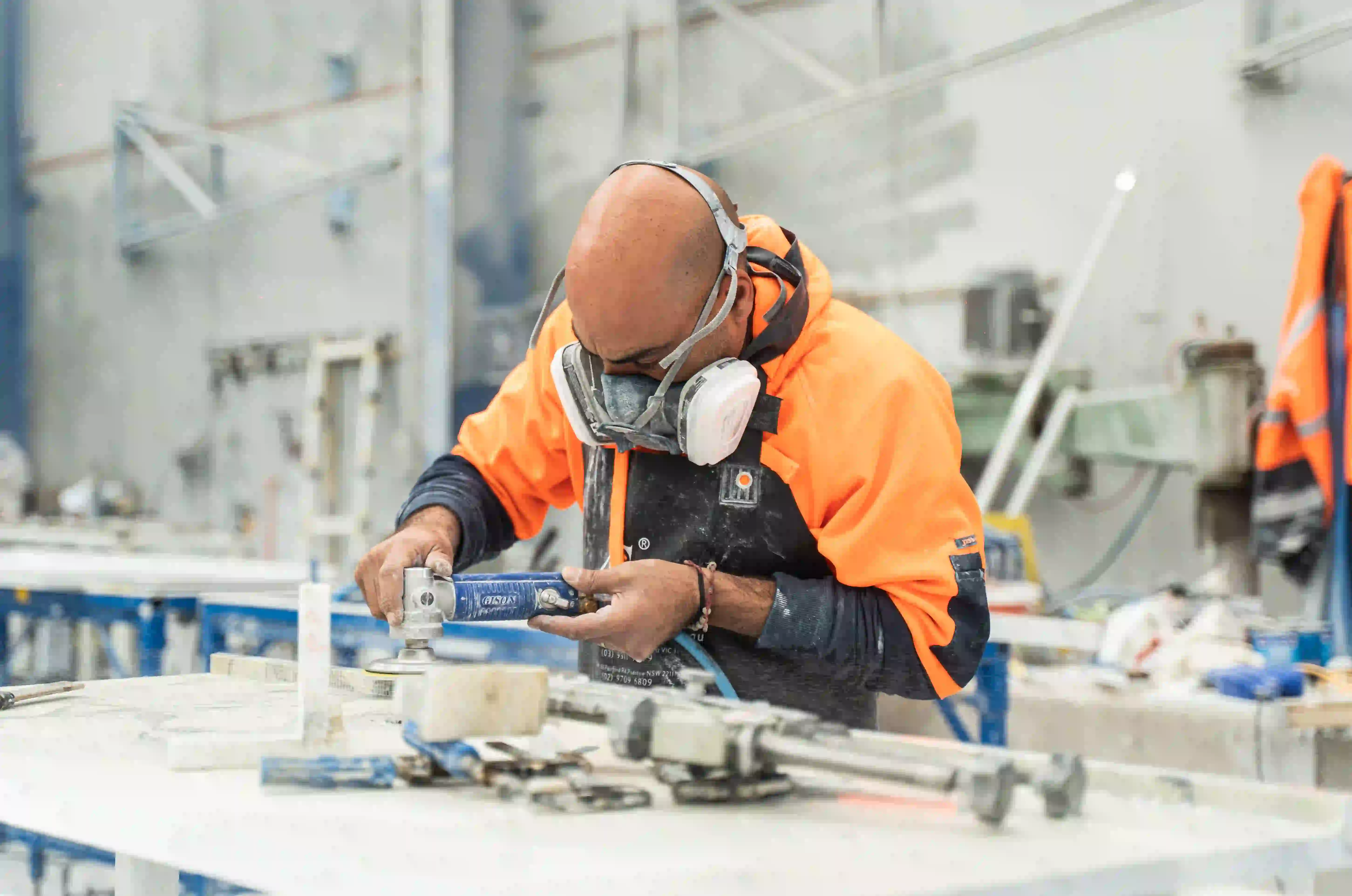 Stonemason polishing a stone benchtop