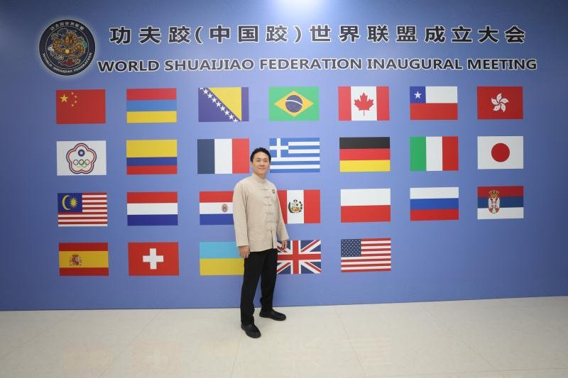 Jan-Yu Weng standing in front of WSJF wall