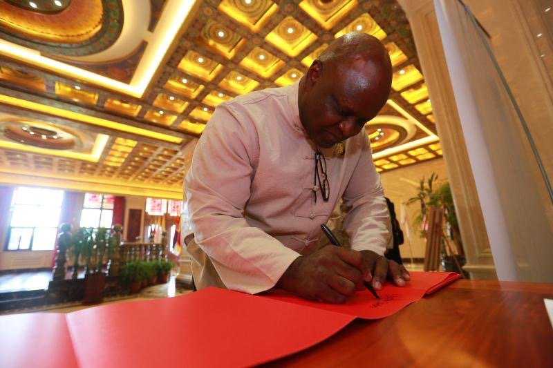 John Ervin Jr.  signs a paper