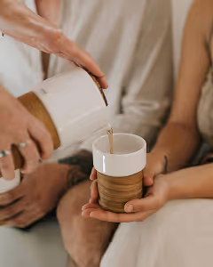 Warm tea being poured into customers cup