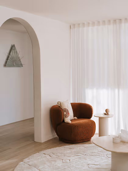 House of Alcheme room with relaxing armchair and curved archway