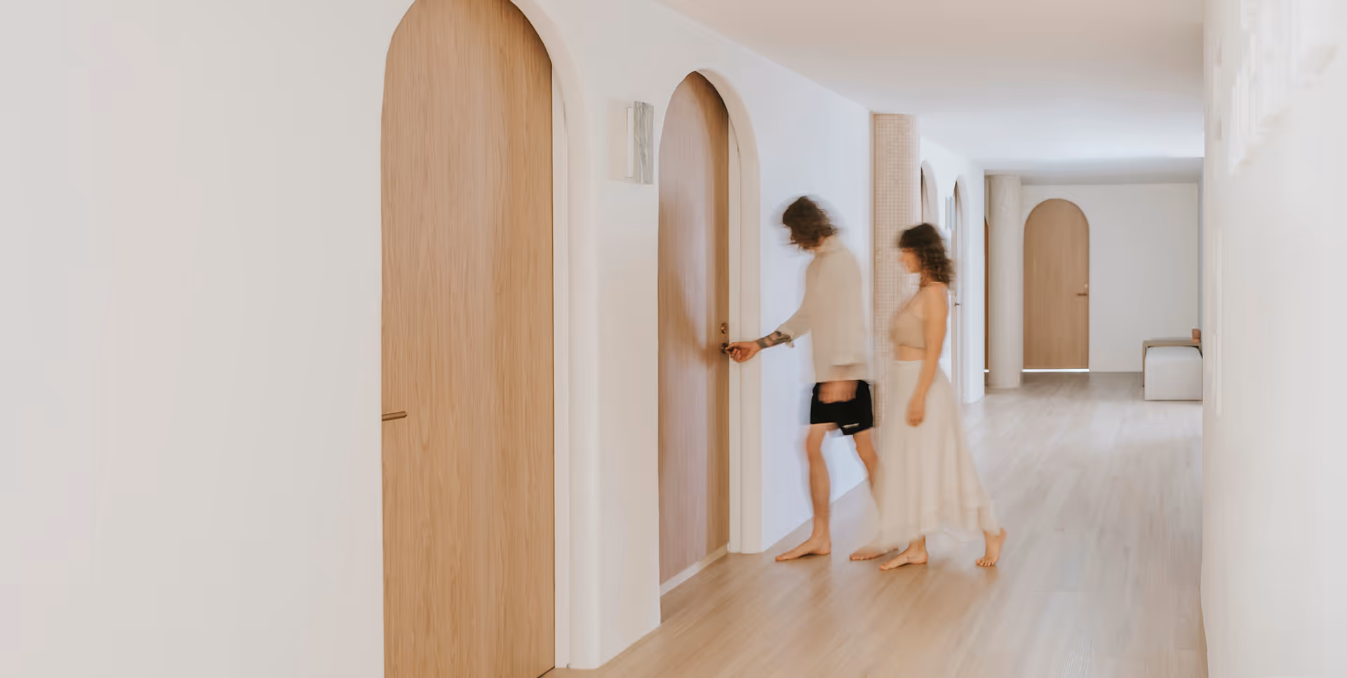 House of Alcheme Clients walking through arched doors