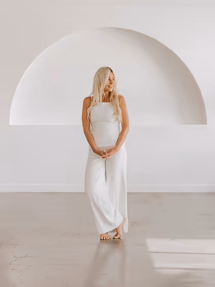 Charlene Dandoulis House of Alcheme in front of curved wall