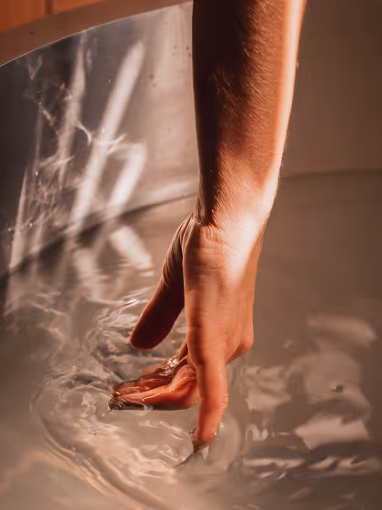 Hand gently touching water