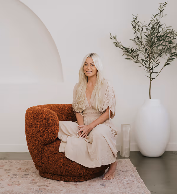 Charlene Dandoulis House of Alcheme sitting on brown couch
