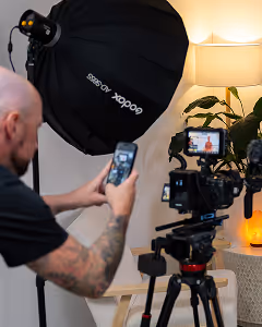 House of Alcheme man filming on iphone