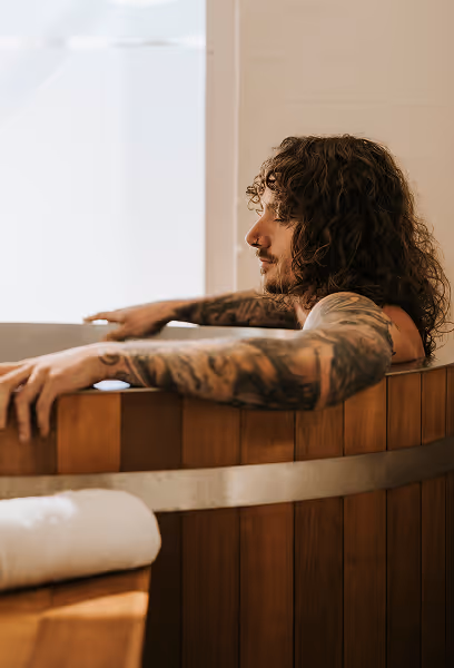 Man relaxing in cold plunge deep concentration