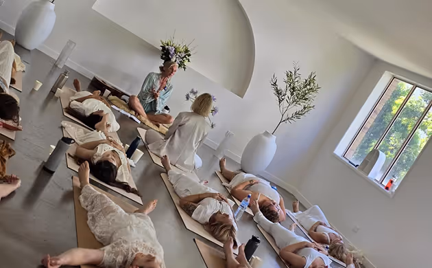 group of women lying on floor meditation