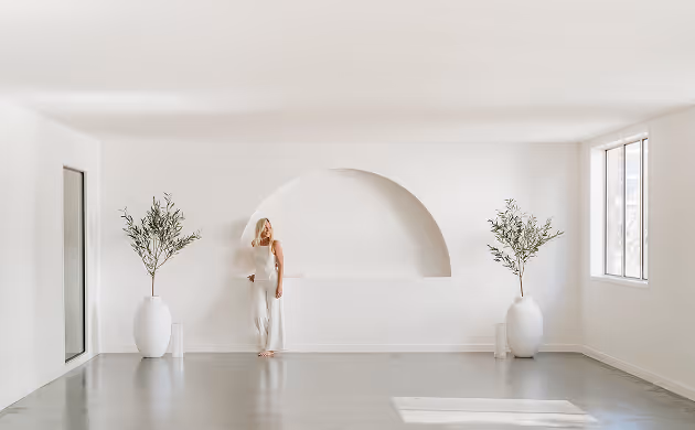 light event space with arched wall lady posing