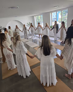 women holding hands in large circle