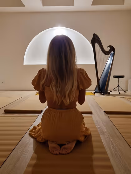 women meditating infront of harp