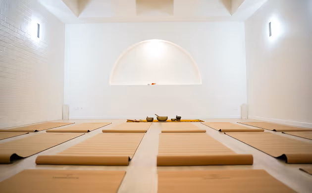 yoga mats in white event space arched wall brown mats