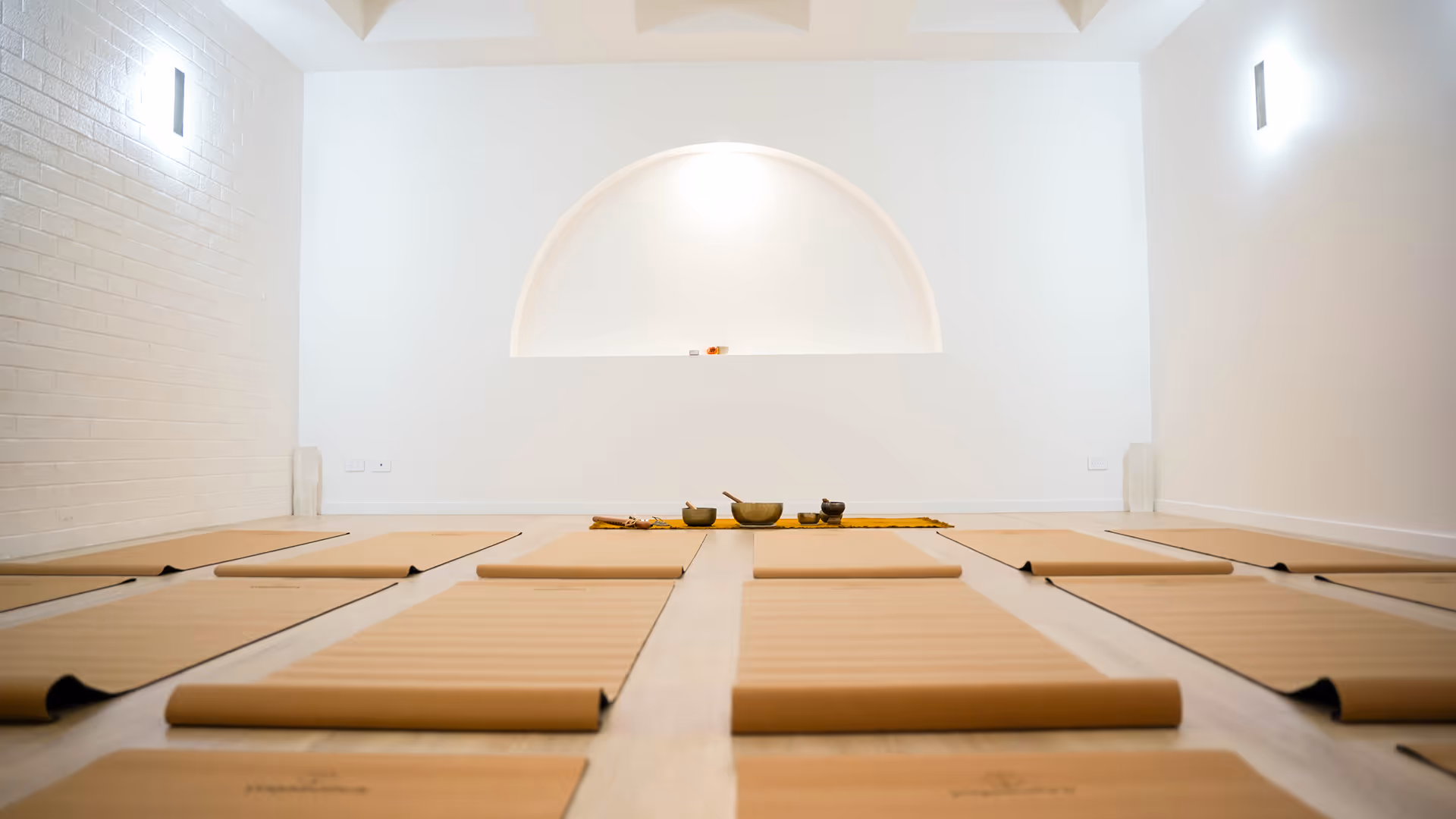 yoga mats in white event space arched wall