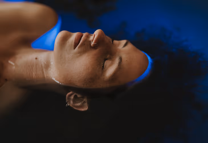 float therapy women relaxing in water blue