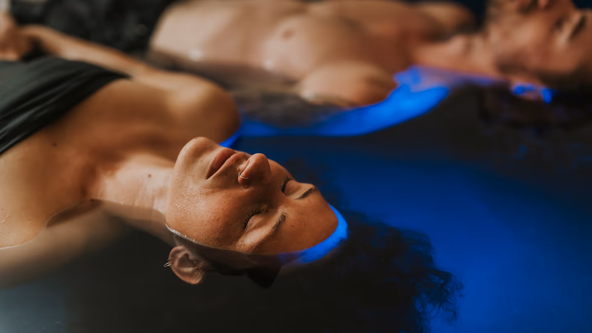 float therapy two people holding hands
