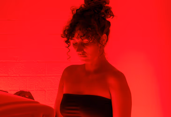 Red Light Therapy lady looking down at the machine