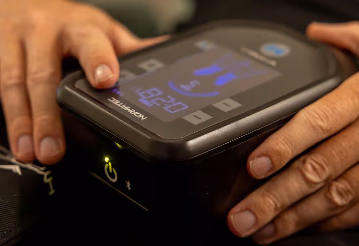 Lymphatic Massage Boots device being held in hands