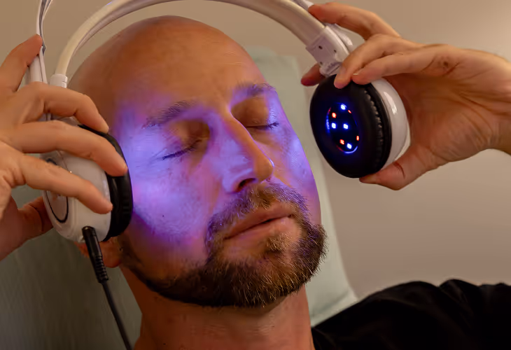 Brain Tap putting on headphones lights on face