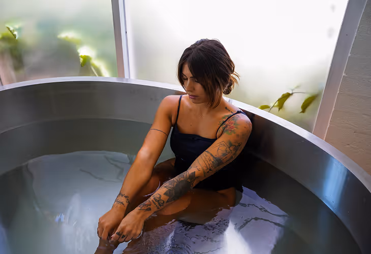 women sitting in ice bath